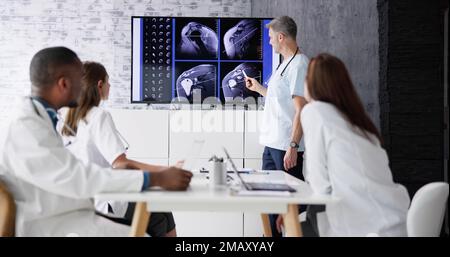 Physician Doctors Looking At Shoulder MRT Scan Stock Photo