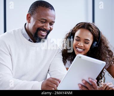 Ill show you how this new system works. two businesspeople working together on a digital tablet in a call centre. Stock Photo