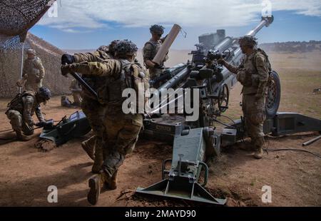 Cannon crew members with 2nd Battalion, 12th Field Artillery Regiment, 1st Stryker Brigade Combat Team, 4th Infantry Division, load an artillery round into an M77 Howitzer during Ivy Mass, June 8, 2022, Fort Carson, Colorado. This is the first time in U.S. Army history that joint assets have been controlled at the division level to enable effects from land up to space. Stock Photo