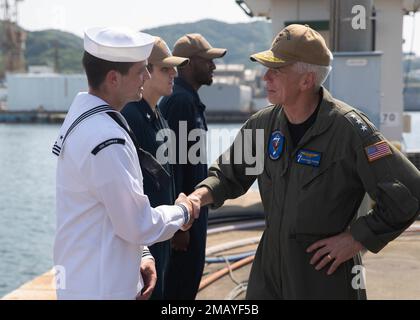 220609-N-LY160-1221 SASEBO, Japan (June 9, 2022) –Vice Adm. Karl Thomas, commander, U.S. 7th Fleet, right, greets Sailors assigned to mine countermeasures ship USS Pioneer (MCM 9), June 9. Stock Photo