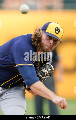 Milwaukee Brewers starter Corbin Burnes adjusts his hair as he