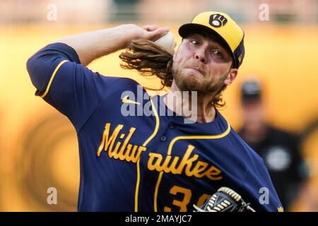 Milwaukee Brewers starter Corbin Burnes adjusts his hair as he pitches  against the Pittsburgh Pirates during the first inning of a baseball game,  Tuesday, Aug. 2, 2022, in Pittsburgh. (AP Photo/Keith Srakocic