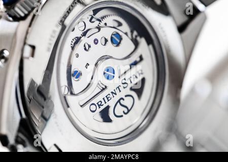 Tokyo, Japan - August 30, 2021: Movement of automatic mechanical wrist watch is behind transparent back case, close-up photo of  Orient Star Mechanica Stock Photo