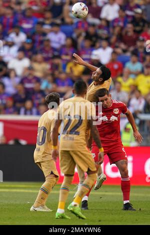 Barcelona midfielder Sergio Busquets heads the ball over AC Milan  midfielder Kevin Prince Boateng, of Ghana, during a Champions League first  leg quarterfinals soccer match, between AC Milan and Barcelona, at the