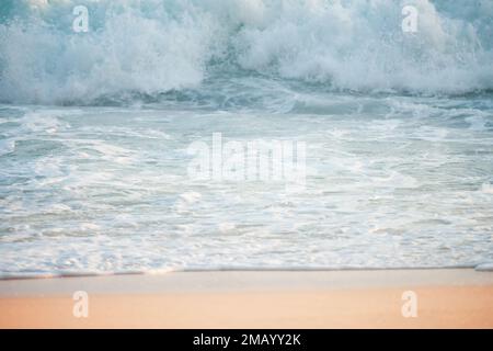 (Selective focus) Stunning view of some ocean waves breaking on the shore during a beautiful sunset. Crushing waves, ocean waves relaxation. Bali. Stock Photo