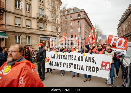 Strasbourg, France - Jan 19, 2023: Large crowd at protest holding large placard against the French government's planned pension reform to push the retirement age from 62 to 64 Stock Photo