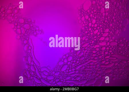 Top view movement of oil bubbles in the liquid. Oil surface multicolored background. Fantastic structure of colorful bubbles. Colorful artistic image Stock Photo