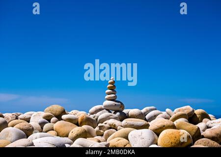 A well-balanced cairn on the beach of the small town of Castle di Tusa, symbol of spirituality and balance. Stock Photo