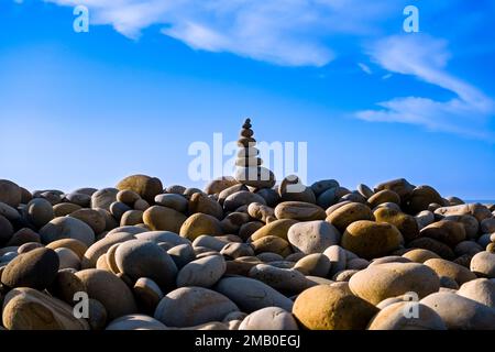 A well-balanced cairn on the beach of the small town of Castle di Tusa, symbol of spirituality and balance. Stock Photo
