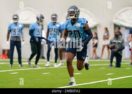 Baltimore Ravens wide receiver Jaylon Moore runs the ball against Tennessee  Titans cornerback Tre Swilling (20) during the second half of a NFL  preseason football game, Thursday, Aug 11, 2022, in Baltimore. (