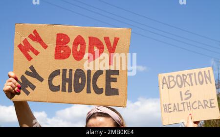 Protesters holding signs My Body My Choice and Abortion Is Healthcare. People with placards supporting abortion rights at protest rally demonstration. Stock Photo