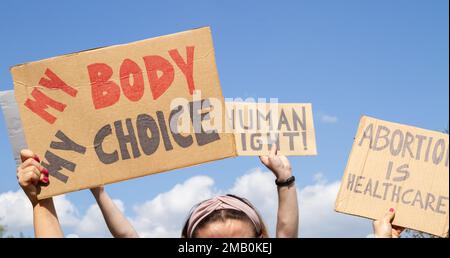 Protesters holding signs My Body My Choice, Abortion Is Healthcare, Human right. Placards supporting abortion rights at protest rally demonstration. Stock Photo