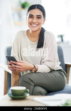 Mobility is key for a busy entrepreneur like me. Portrait of a young businesswoman using a cellphone in an office. Stock Photo