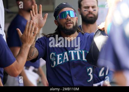 Seattle Mariners' Sam Haggerty is greeted in the dugout after