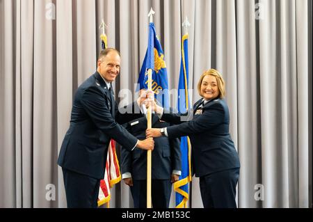 Col. Matt Husemann, left, 436th Airlift Wing commander, passes the guidon to Col. Peggy Dickson, 436th Medical Group commander, during the 436th MDG Change of Command ceremony at Dover Air Force Base, Delaware, June 9, 2022. Dickson was previously the commander of the 10th Dental Squadron at the U.S. Air Force Academy in Colorado. Stock Photo