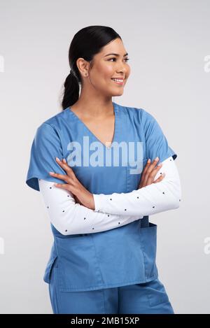 Doctor means- never listen with your chest. a beautiful young doctor standing with arms folded against a white background. Stock Photo