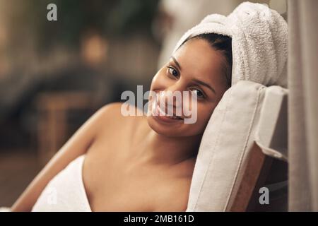 Because you need time for yourself. a woman wearing a towel around her head while enjoying a spa day. Stock Photo