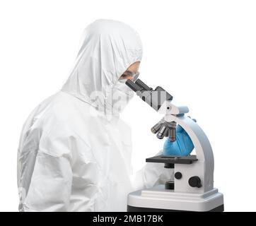 Worker wears medical protective suit or white coverall suit with mask and goggles look through microscope isolated on white background Stock Photo