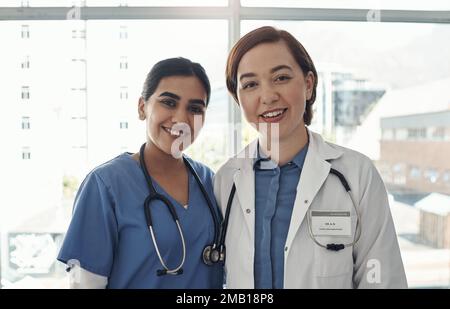 Were here because we have the desire to care. two young health workers in a hospital. Stock Photo