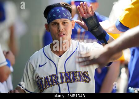 Seattle Mariners' Sam Haggerty is greeted in the dugout after