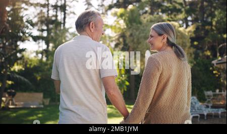 Growing old with you is my joy. a mature couple enjoying a walk in their yard. Stock Photo