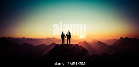 Silhouette Couple of man and woman reaching summit enjoying freedom and looking towards mountains sunset. Alps, Allgaeu, Bavaria, Germany. Stock Photo