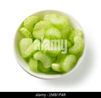 bowl of sliced celery isolated on white background, top view Stock Photo