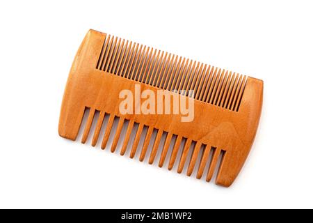 Small brown wooden comb for hair of beard isolated on white Stock Photo
