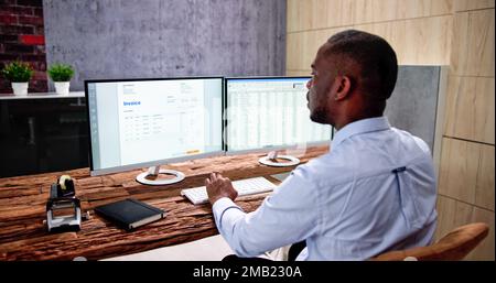 Medical Codes And Accounts Manager In Office With Bill Stock Photo