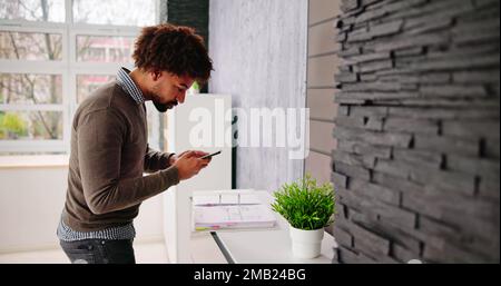 Stealing Trade Secret. Taking Photo Using Phone In Office Stock Photo
