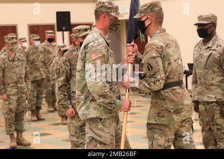 Army Reserve Capt. Ryan Johnston, incoming commander, Headquarters and Headquarters Detachment, 63rd Readiness Division, left, receives the 63rd RD HHD guidon from Army Reserve Maj. Gen. Miles Davis, commanding general, 63rd RD, center, as Army Reserve Maj. Freddie Scott, the outgoing commander, HHD, 63rd RD relinquishes command during a change of command ceremony, June 10, 2022, at the Sgt. James T. Witkowski Armed Forces Reserve Center in Mountain View, Calif. Stock Photo