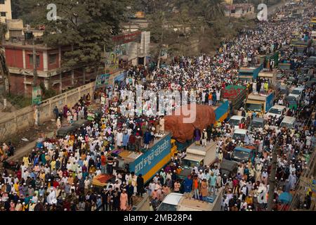 Dhaka, Bangladesh. 20th Jan, 2023. Muslim devotees pray in the middle of a busy road junction, causing traffic to come to a standstill, in Tongi, Dhaka, Bangladesh during Bishwa Ijtema, one of the major Islamic religious gatherings observed annually. Dedicated prayer grounds are not enough to handle this huge number of people, so large numbers of people come to Tongi, the main street of Dhaka. All the ground transportation and pedestrian crossings are suspended during that time. The Bishwa Ijtema (Global Congregation) is an annual gathering of Muslims in Tongi, by the banks of the River Turag, Stock Photo