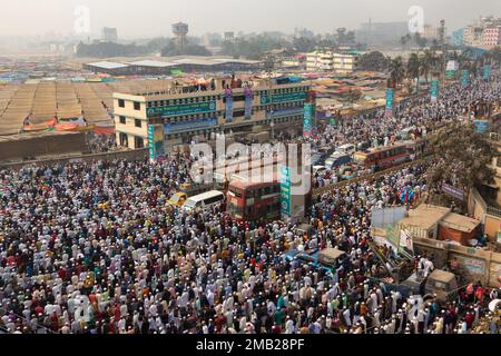 Dhaka, Bangladesh. 20th Jan, 2023. Muslim devotees pray in the middle of a busy road junction, causing traffic to come to a standstill, in Tongi, Dhaka, Bangladesh during Bishwa Ijtema, one of the major Islamic religious gatherings observed annually. Dedicated prayer grounds are not enough to handle this huge number of people, so large numbers of people come to Tongi, the main street of Dhaka. All the ground transportation and pedestrian crossings are suspended during that time. The Bishwa Ijtema (Global Congregation) is an annual gathering of Muslims in Tongi, by the banks of the River Turag, Stock Photo