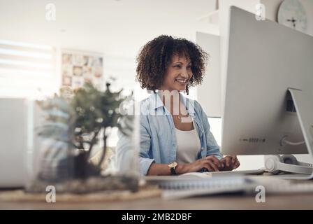 I really enjoyed writing this article. an attractive young woman sitting alone at home and using her computer. Stock Photo