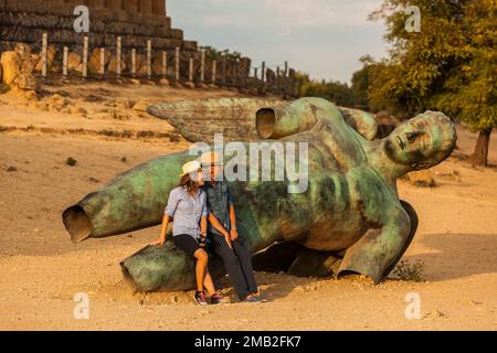 Italy, Sicily: Agrigento, Valle dei Templi. In front of the Temple of Concordia, the statue of Icarus, donated by the Polish sculptor Igor Mitoraj Stock Photo