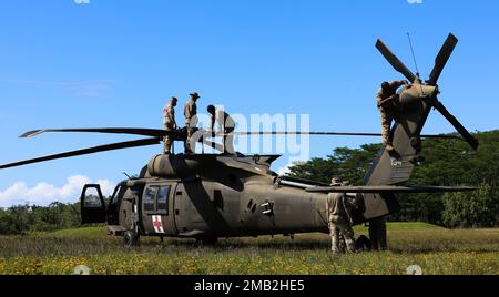 Army National Guard Soldiers (HIARNG) from Detachment 1, Golf Company, 1st Battalion, 189th Aviation Regiment and Detachment 1, Golf Company, 3rd Battalion, 126th Aviation Regiment, perform end-of-flight maintenance checks on a UH-60 Black Hawk helicopter at Hilo, Hawaii, June 10, 2022. The two HIARNG regiments participated in a multi-day training exercise, which involved flight operations, UH-60 helicopter repairers, weather forecasting from the U.S. Air Force, petroleum supply specialists, flight crew chief, flight paramedics and pilots. Stock Photo