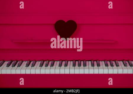 the concept of Valentine's day. The heart is on the pink piano Stock Photo