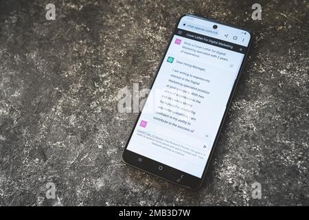 ChatGPT Open AI chat bot on phone screen. Chat GPT writes a cover letter, helping in job searching. Swansea, UK - January 10, 2023. Stock Photo