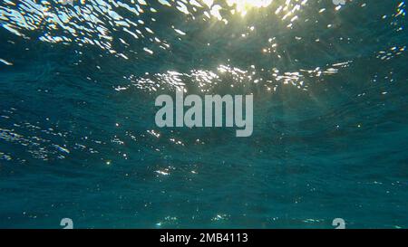 Sunrays penetrate through the surface of the water. Underwater light creates a beautiful veil, consisting of sunlight. range rays of the sun at Stock Photo