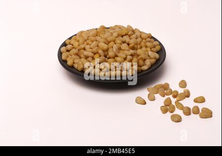 Close-up of fresh peeled pine nuts isolated Stock Photo
