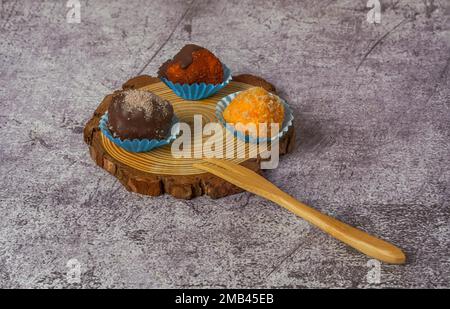Truffles of different flavors on a wooden disk Stock Photo