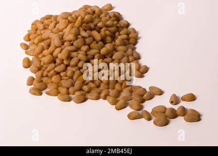 Close-up of fresh peeled pine nuts isolated Stock Photo