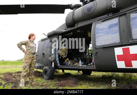 Hawaii Army National Guard (HIARNG) Sgt. Daisy Moore, a flight paramedic with Detachment 1, Golf Company, 1st Battalion, 189th Aviation Regiment, pauses to ensure the UH-60 Black Hawk helicopter is prepared for medevac exercise at Hilo, Hawaii, June 11, 2022. HIARNG Soldiers from two aviation regiments participated in a multi-day training operation. Stock Photo