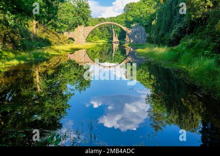 Rakotz Bridge, also Devil's Bridge, and basalt columns, the organ, in the Azalea and Rhododendron Park Kromlau, Gablenz, Saxony, Germany Stock Photo