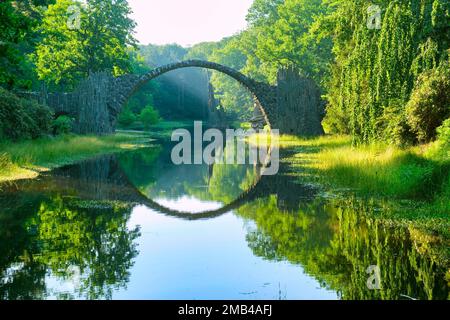 Rakotz Bridge, also Devil's Bridge, and basalt columns, the organ, in the Azalea and Rhododendron Park Kromlau, Gablenz, Saxony, Germany Stock Photo