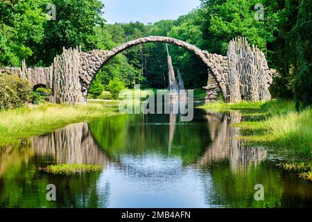 Rakotz Bridge, also Devil's Bridge, and basalt columns, the organ, in the Azalea and Rhododendron Park Kromlau, Gablenz, Saxony, Germany Stock Photo