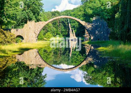 Rakotz Bridge, also Devil's Bridge, and basalt columns, the organ, in the Azalea and Rhododendron Park Kromlau, Gablenz, Saxony, Germany Stock Photo