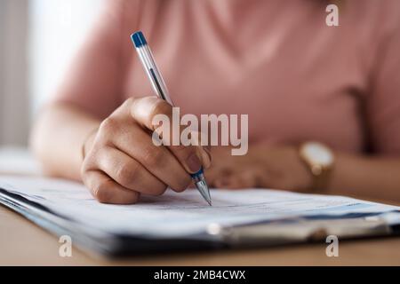 Making a grocery list. a woman working from home. Stock Photo