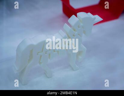 Object printed on 3D printer from plastic. The object a prototype of an toy horse printed on a 3D printer from white plastic. 3D volumetric model. Concept new modern printing technology Stock Photo