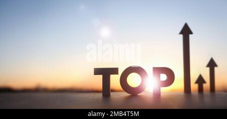 Up high rising arrow and TOP with bright rising sun and new year sunrise and education stock finance economy industry growth investment target concept Stock Photo